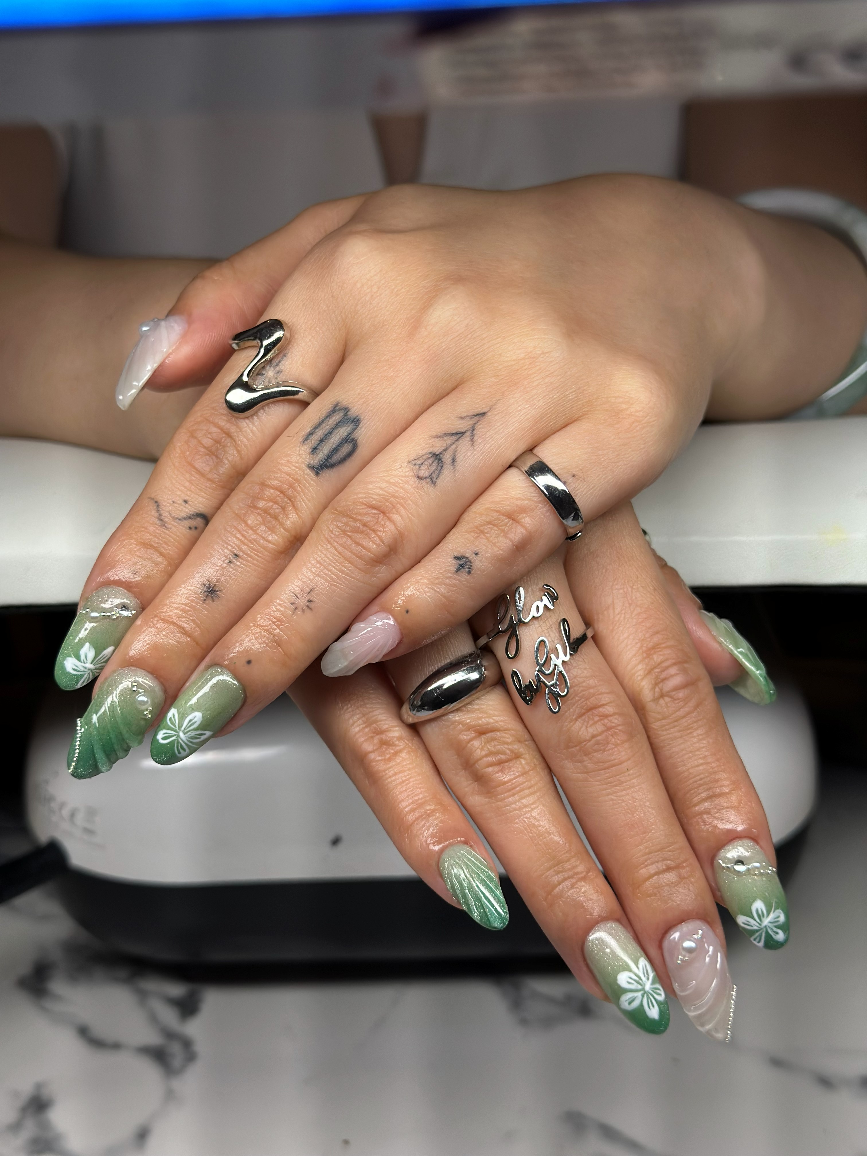 Green ombre nails with white floral art