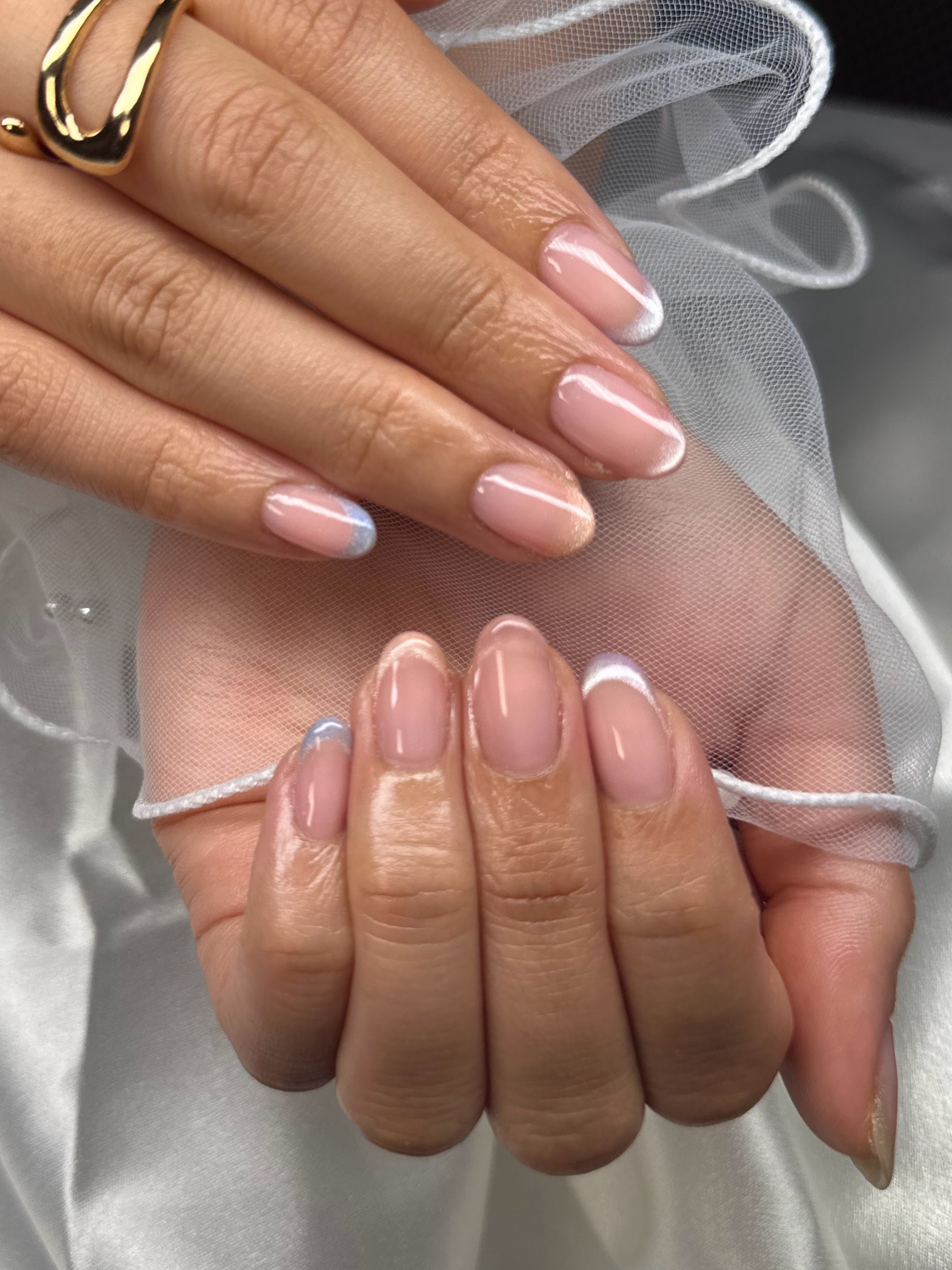 Nude nails with clean white French and subtle aurora pearl finish